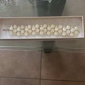 White Moonstone thermoset bracelet placed in a gold tone setting. Classic style!